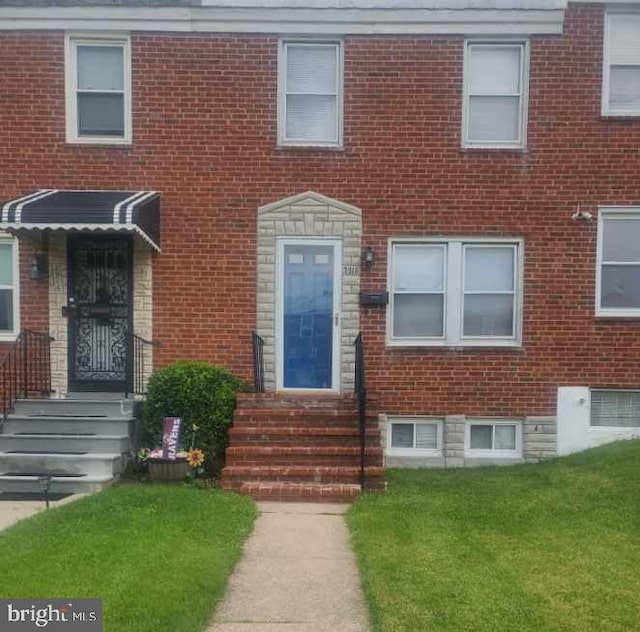 3918 Dudley Ave, Baltimore, MD 21213 - multi unit property featuring a front yard and brick siding