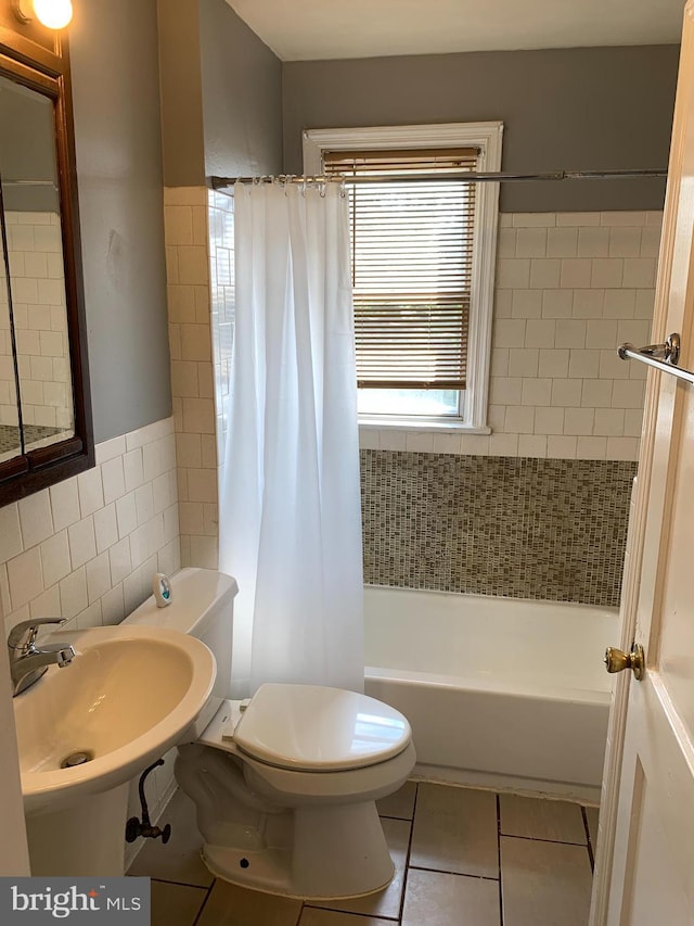 3918 Dudley Ave, Baltimore, MD 21213 - full bath with toilet, shower / tub combo with curtain, tile walls, a sink, and tile patterned flooring