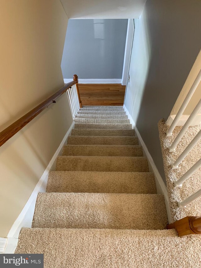 3918 Dudley Ave, Baltimore, MD 21213 - stairs with baseboards and wood finished floors
