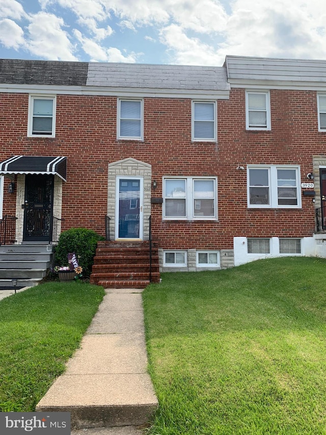 3918 Dudley Ave, Baltimore, MD 21213 - view of front of house with entry steps, brick siding, and a front yard