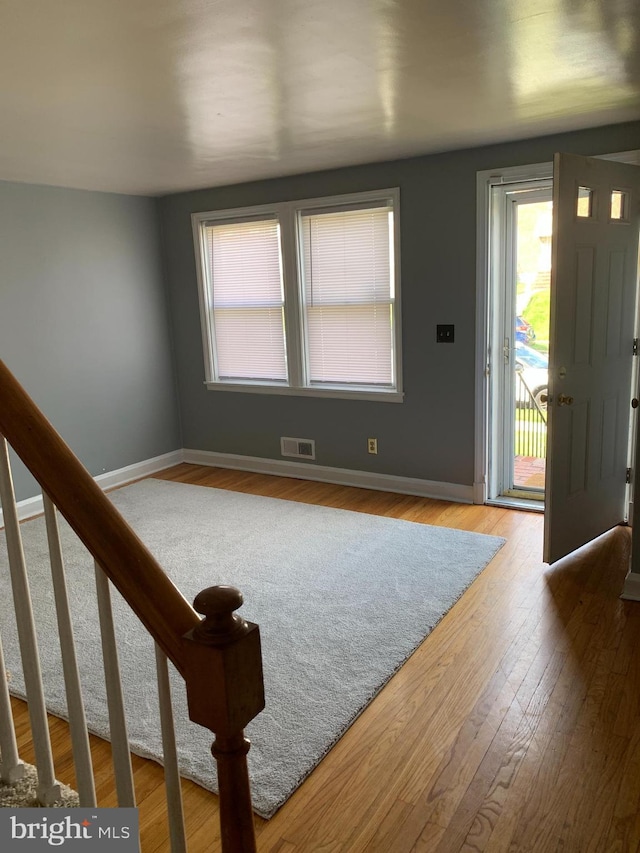 3918 Dudley Ave, Baltimore, MD 21213 - foyer entrance featuring baseboards, wood finished floors, and stairs