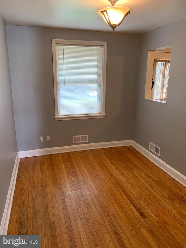 3918 Dudley Ave, Baltimore, MD 21213 - empty room featuring wood finished floors and baseboards
