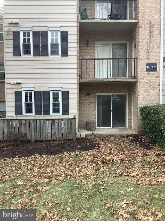 18302 Streamside Dr Unit 101, Gaithersburg, MD 20879 - back of house featuring brick siding and a balcony