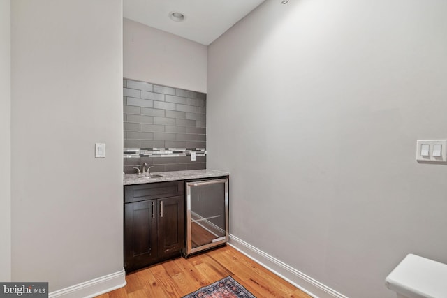 1444 N Myrtlewood St, Philadelphia, PA 19121 - indoor wet bar with wine cooler, light wood finished floors, and baseboards