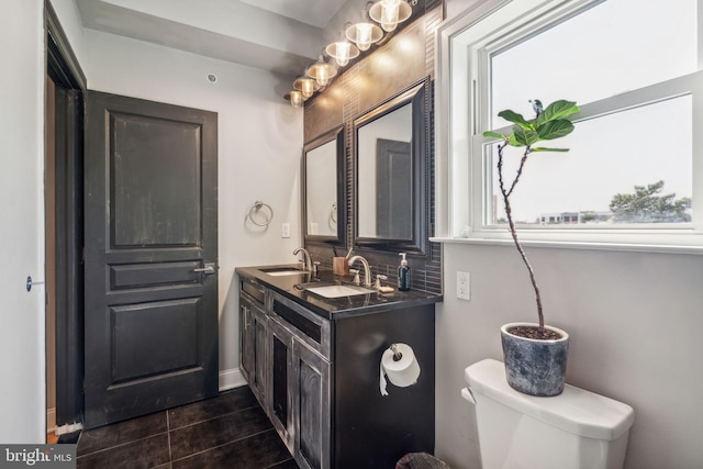1444 N Myrtlewood St, Philadelphia, PA 19121 - bathroom with toilet, double vanity, tile patterned flooring, and backsplash