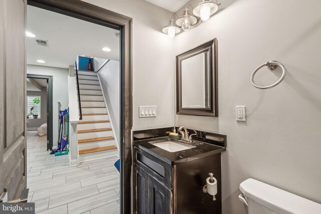 1444 N Myrtlewood St, Philadelphia, PA 19121 - bathroom featuring toilet, vanity, and baseboards
