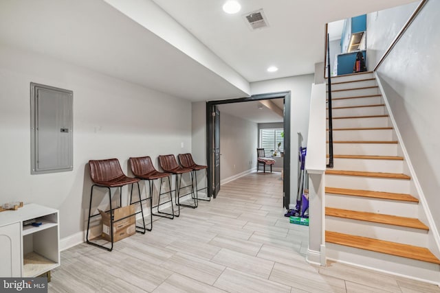 1444 N Myrtlewood St, Philadelphia, PA 19121 - stairs featuring electric panel, baseboards, wood finish floors, and recessed lighting