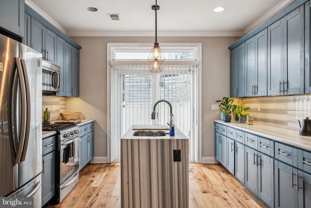 1444 N Myrtlewood St, Philadelphia, PA 19121 - kitchen featuring appliances with stainless steel finishes, a sink, decorative backsplash, light wood-type flooring, and ornamental molding