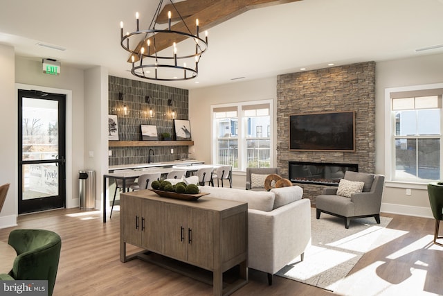 21 Kay Chiarello Way, Hamilton, NJ 08690 - living room with light wood-type flooring, a chandelier, a stone fireplace, baseboards, and recessed lighting