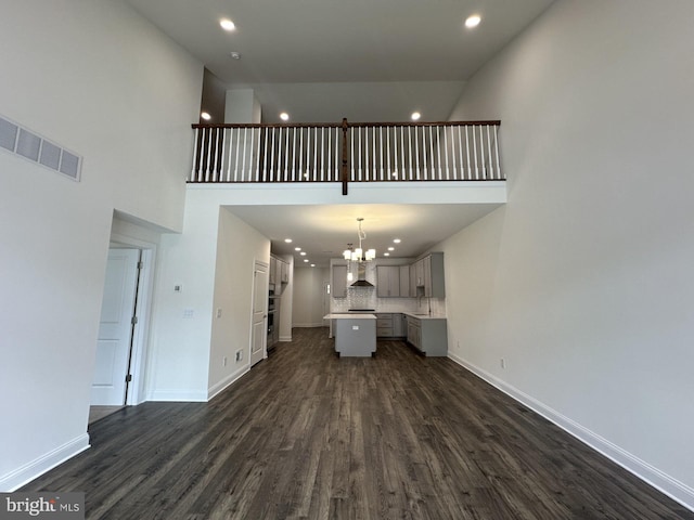 21 Kay Chiarello Way, Hamilton, NJ 08690 - unfurnished living room featuring recessed lighting, a towering ceiling, dark wood-style floors, a chandelier, and baseboards
