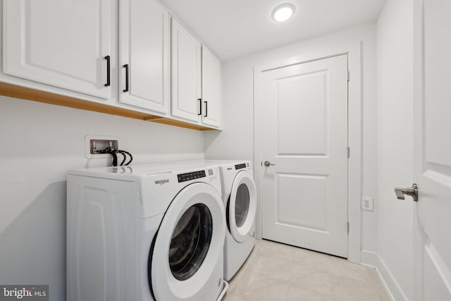 210 Decoverly Dr Unit 407, Gaithersburg, MD 20878 - washroom with cabinet space, washer and clothes dryer, light tile patterned floors, and baseboards