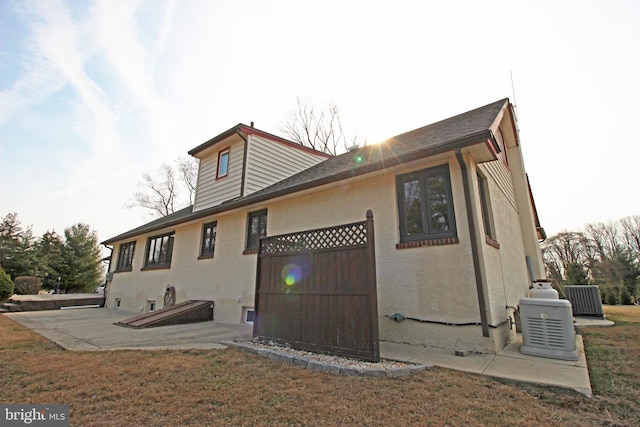 2732 Old Cedar Grove Rd, Broomall, PA 19008 - back of house featuring stucco siding, a yard, and cooling unit