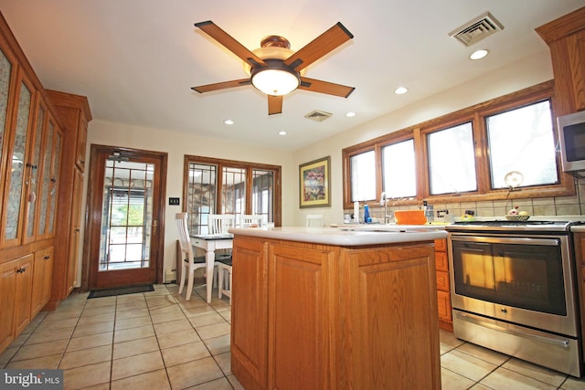 2732 Old Cedar Grove Rd, Broomall, PA 19008 - kitchen featuring appliances with stainless steel finishes, light tile patterned floors, light countertops, a ceiling fan, and a sink