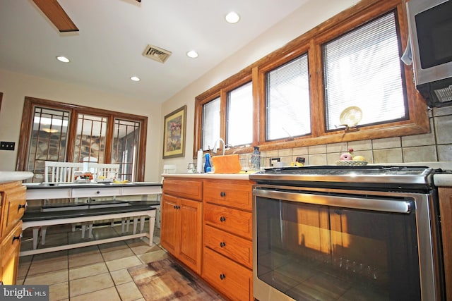 2732 Old Cedar Grove Rd, Broomall, PA 19008 - kitchen with appliances with stainless steel finishes, recessed lighting, light countertops, light tile patterned floors, and decorative backsplash