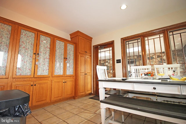 2732 Old Cedar Grove Rd, Broomall, PA 19008 - kitchen with light tile patterned floors, brown cabinetry, and glass insert cabinets
