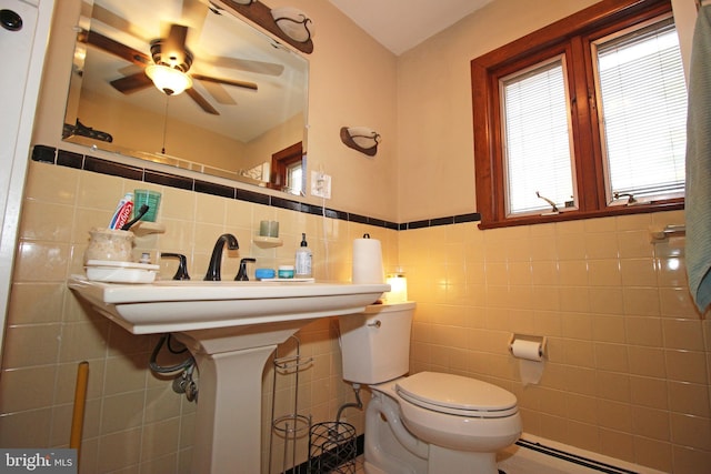 2732 Old Cedar Grove Rd, Broomall, PA 19008 - half bathroom featuring tile walls, toilet, a ceiling fan, a baseboard radiator, and wainscoting