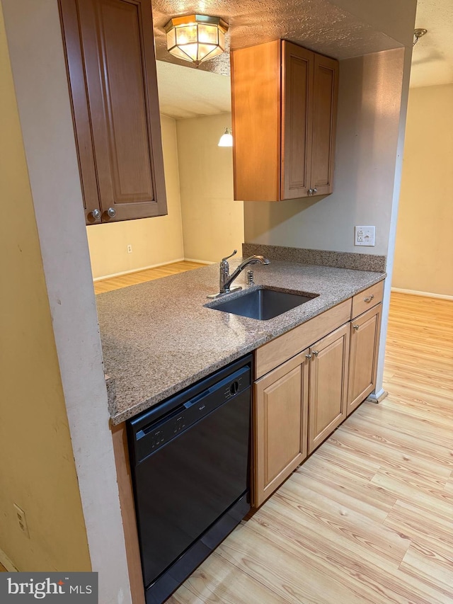 8406 Rainbow Bridge Ln, Springfield, VA 22153 - kitchen featuring black dishwasher, light wood-style flooring, and light stone counters