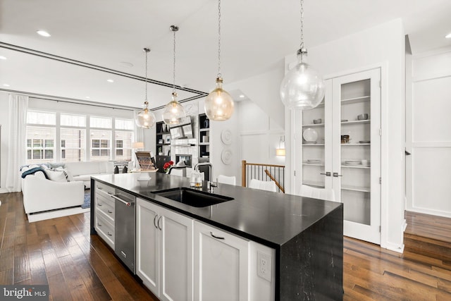 1741 Mckenna Point Dr Unit 2701, Mclean, VA 22102 - kitchen with open floor plan, dark countertops, dark wood-style floors, an island with sink, and a fireplace