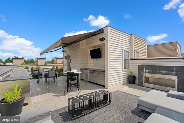 1741 Mckenna Point Dr Unit 2701, Mclean, VA 22102 - view of patio / terrace with exterior kitchen, outdoor dining space, and a multi sided fireplace