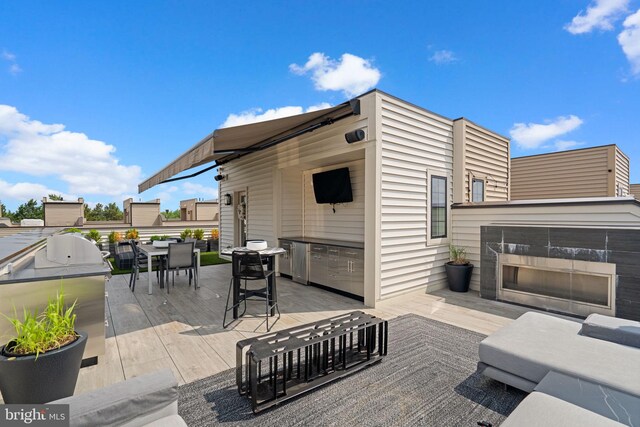 1741 Mckenna Point Dr Unit 2701, Mclean, VA 22102 - view of patio / terrace featuring an outdoor kitchen, outdoor dining space, and a multi sided fireplace
