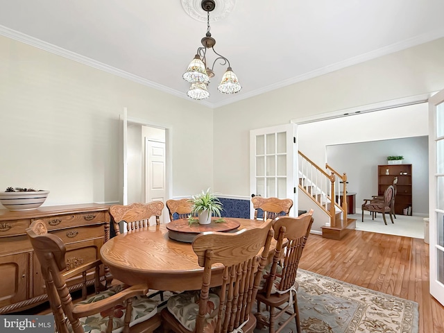 5590 Broadmoor Ter N, Ijamsville, MD 21754 - dining space with crown molding, stairway, wood finished floors, and a chandelier