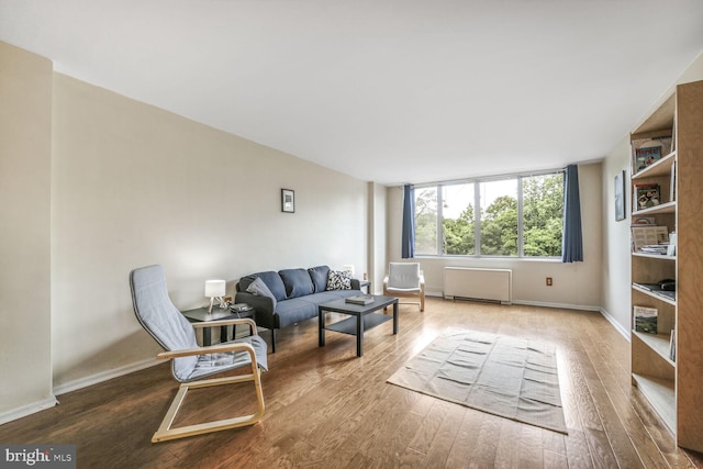 2939 Van Ness St NW Unit 608, Washington, DC 20008 - living room featuring wood finished floors, radiator, and baseboards