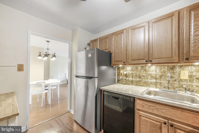 2939 Van Ness St NW Unit 608, Washington, DC 20008 - kitchen featuring black dishwasher, freestanding refrigerator, a sink, backsplash, and light wood-style flooring