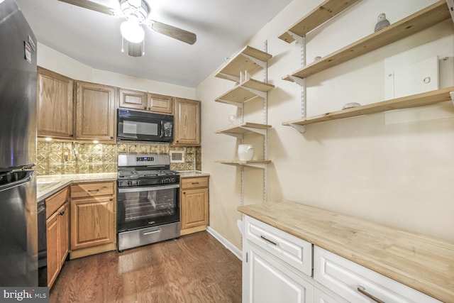 2939 Van Ness St NW Unit 608, Washington, DC 20008 - kitchen with open shelves, stainless steel gas stove, black microwave, and freestanding refrigerator