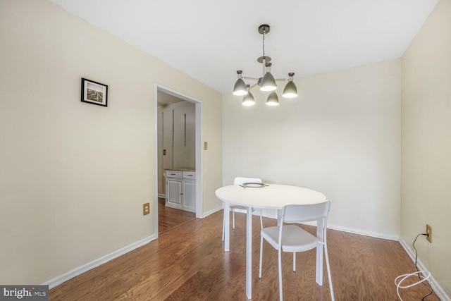 2939 Van Ness St NW Unit 608, Washington, DC 20008 - dining space featuring a chandelier, wood finished floors, and baseboards