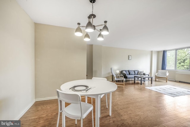 2939 Van Ness St NW Unit 608, Washington, DC 20008 - dining space featuring a chandelier, wood finished floors, and baseboards