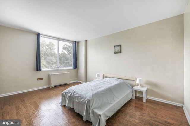 2939 Van Ness St NW Unit 608, Washington, DC 20008 - bedroom with radiator heating unit, wood finished floors, and baseboards