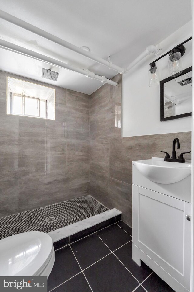 170 Drexel Ave, Lansdowne, PA 19050 - full bathroom with tile walls, tile patterned flooring, vanity, a tile shower, and toilet