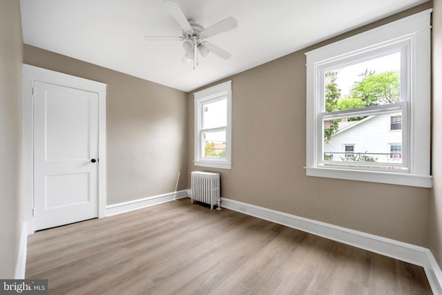 170 Drexel Ave, Lansdowne, PA 19050 - unfurnished room with radiator heating unit, light wood finished floors, baseboards, and a ceiling fan