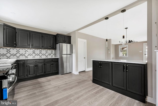 170 Drexel Ave, Lansdowne, PA 19050 - kitchen featuring appliances with stainless steel finishes, light countertops, decorative backsplash, a chandelier, and light wood finished floors