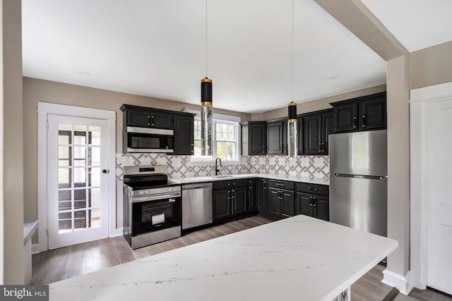 170 Drexel Ave, Lansdowne, PA 19050 - kitchen featuring appliances with stainless steel finishes, backsplash, a sink, and pendant lighting