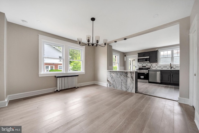 170 Drexel Ave, Lansdowne, PA 19050 - kitchen featuring radiator heating unit, stainless steel appliances, a chandelier, and plenty of natural light