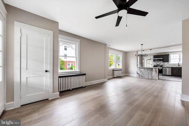 170 Drexel Ave, Lansdowne, PA 19050 - unfurnished living room featuring radiator heating unit, a chandelier, and light wood-style floors