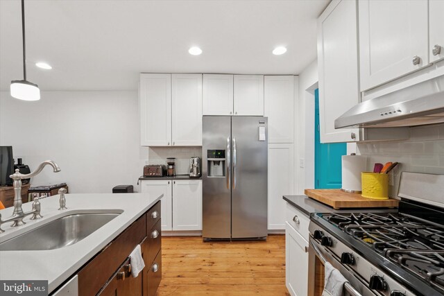 1620 E Berks St, Philadelphia, PA 19125 - kitchen featuring stainless steel appliances, a sink, exhaust hood, backsplash, and light wood-style floors