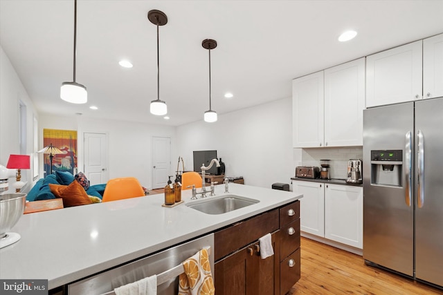 1620 E Berks St, Philadelphia, PA 19125 - kitchen with stainless steel fridge, white cabinets, a sink, light wood-style floors, and pendant lighting