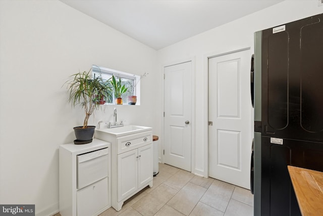 1620 E Berks St, Philadelphia, PA 19125 - hallway with washer / dryer, a sink, and light tile patterned floors