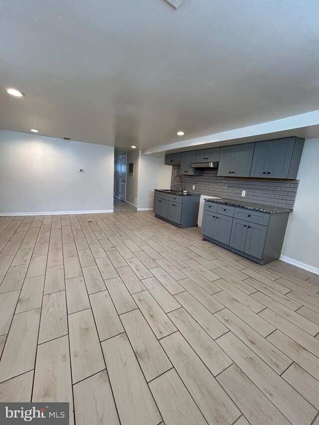 5221 N 8th St, Philadelphia, PA 19120 - kitchen featuring baseboards, under cabinet range hood, tasteful backsplash, recessed lighting, and gray cabinets