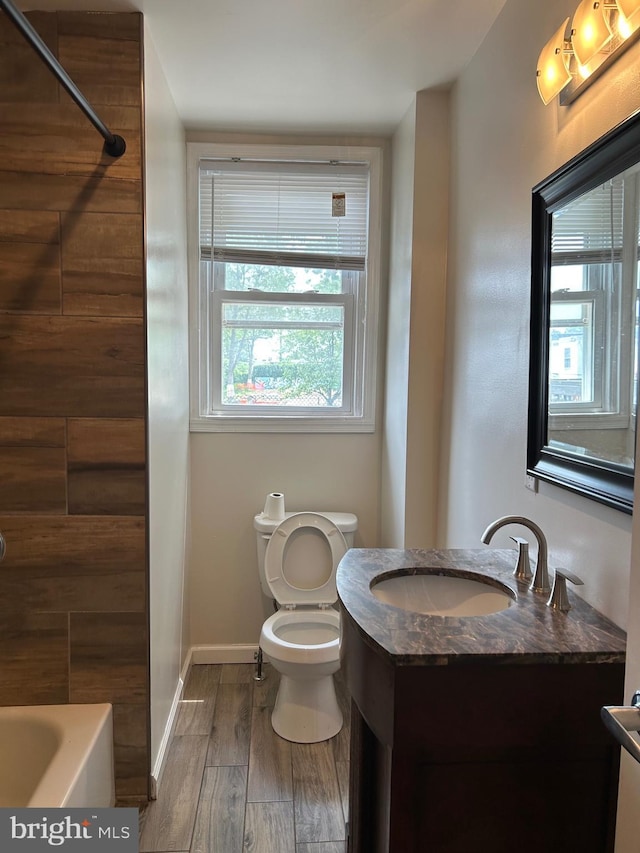 5221 N 8th St, Philadelphia, PA 19120 - bathroom featuring vanity, toilet, wood finished floors, and baseboards