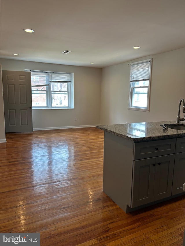 5221 N 8th St, Philadelphia, PA 19120 - kitchen with a sink, healthy amount of natural light, dark wood-type flooring, stone countertops, and recessed lighting