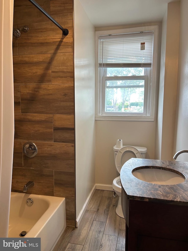 5221 N 8th St, Philadelphia, PA 19120 - bathroom with toilet, wood finished floors, baseboards, bathing tub / shower combination, and vanity