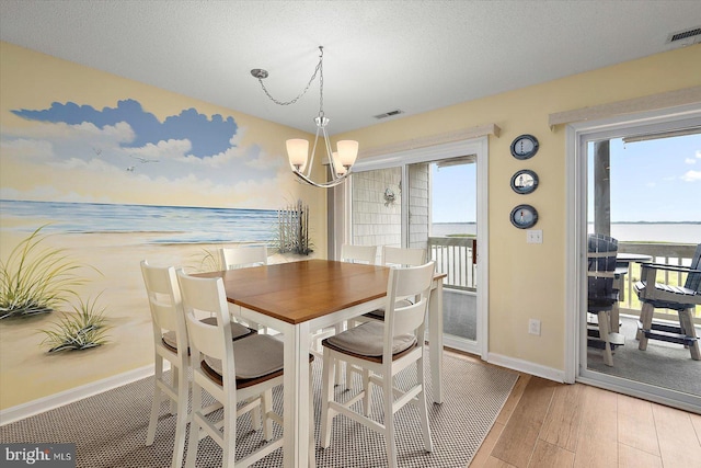 205 125th St Unit M253H8, Ocean City, MD 21842 - dining space featuring a chandelier, baseboards, and wood finished floors