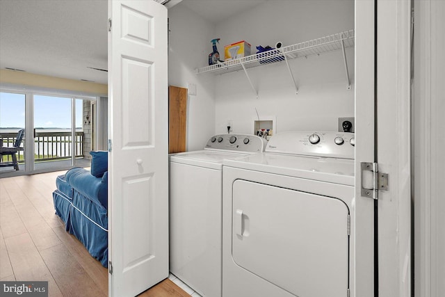 205 125th St Unit M253H8, Ocean City, MD 21842 - laundry area featuring washer and dryer and light wood finished floors