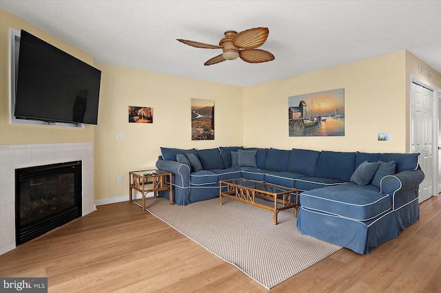 205 125th St Unit M253H8, Ocean City, MD 21842 - living room with a ceiling fan, wood finished floors, a fireplace, and baseboards