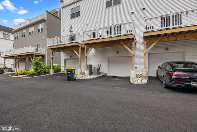 108 Annapolis St, Bensalem, PA 19020 - rear view of property featuring a garage, central AC unit, and driveway
