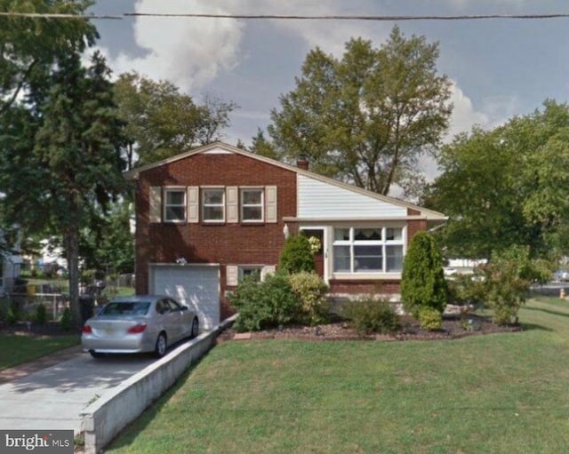 2603 Manall Ave, Pennsauken, NJ 08109 - split level home with asphalt driveway, an attached garage, a front yard, and brick siding