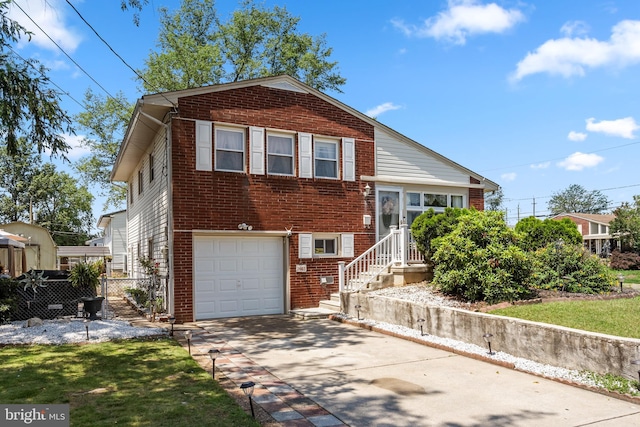 2603 Manall Ave, Pennsauken, NJ 08109 - tri-level home with a garage, brick siding, and driveway